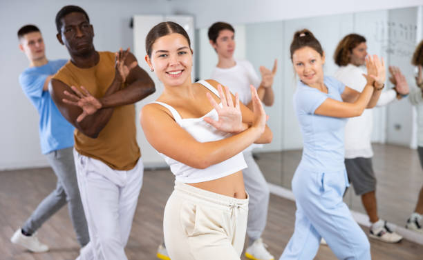 istock Group of active women and men practicing energetic dance in modern dance studio 1494936918
