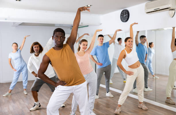 istock African american man practicing active  dance moves during rehearsal with group in dancing studio. 1494936933
