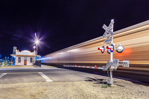 Railroad crossing by night with sign in kingman