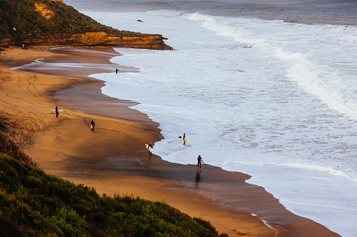 TORQUAY, AUSTRALIA - MAY 28 2023: Surfers go out to tackle huge swell at Bells Beach near Torquay, Victoria, Australia