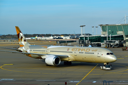 Jung District, Incheon, South Korea: Etihad Airways Boeing 787-9 (A6-BLJ, MSN 39657) - pushback using a towbarless tractor - Incheon International Airport. Etihad (Arabic for Union), is the national airline of the United Arab Emirates based in Abu Dhabi. Terminal in the background.