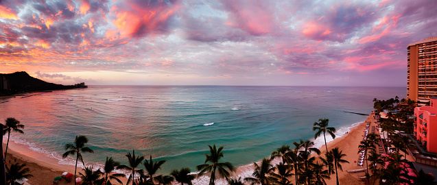 Waikiki Beach, Hawaii, as dawn lights up the clouds