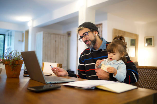 istock father and daughter looking at laptop 1494953082