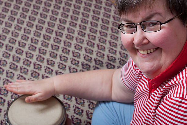 istock Mentally disabled woman smiling with drum 149495492