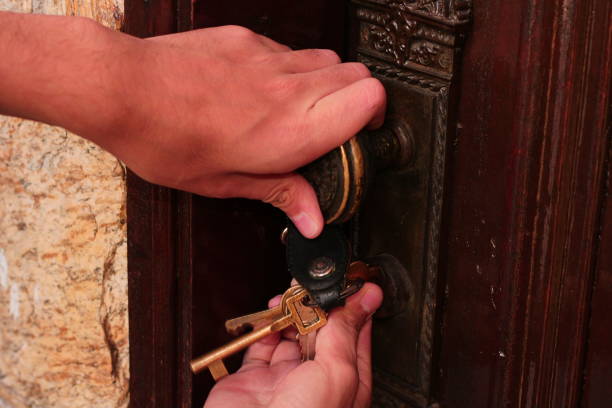 istock Person Opening a Door with Keys 1494961102