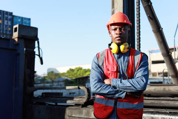 istock Foreman engineer standing and crossed arms while looking at camera with happy and success face. Confident engineering work at container cargo site and checking industrial container cargo freight ship 1494967205