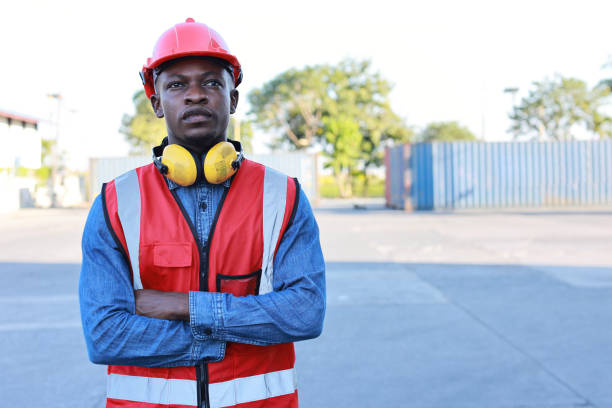 istock Foreman engineer standing and crossed arms while looking at camera with happy and success face. Confident engineering work at container cargo site and checking industrial container cargo freight ship 1494967221