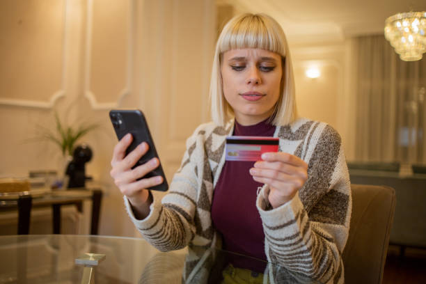 istock Woman using her credit card to shop online 1494967672