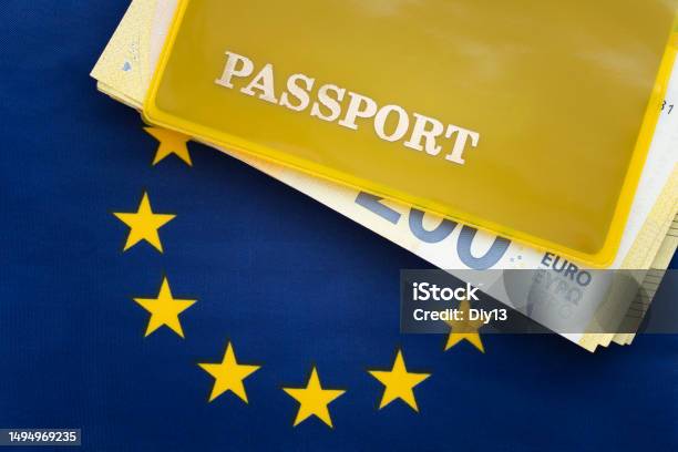 Flag Of European Union With Passport Travel Visa And Citizenship Concept Residence Permit In The Country A Yellow Document With The Inscription Passport Is On Flag Close Up Top View Stock Photo - Download Image Now