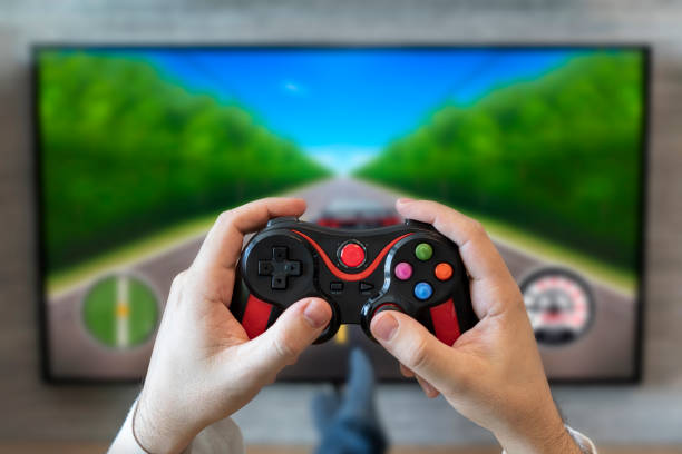 istock car racing simulator. gaming gameplay tv. fun game on gamepad. game controller video console playing player holding. hobby playful enjoyment view concept. 1494969249