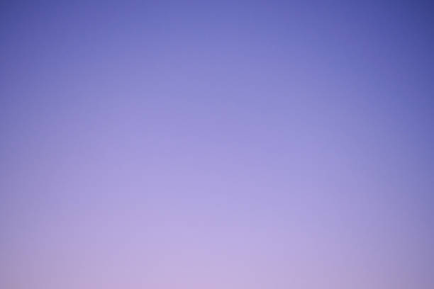 Sunset sky gradient from blue to purple, copy space. Clear sunset sky with the bright light of the setting sun