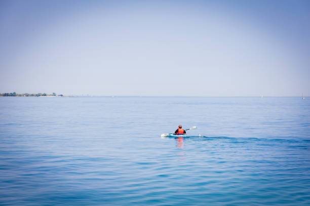 A single kayaker relaxes as he paddles through Lake Ontario outside the RC Harris Water Filtration Plant in Toronto, Ontario.