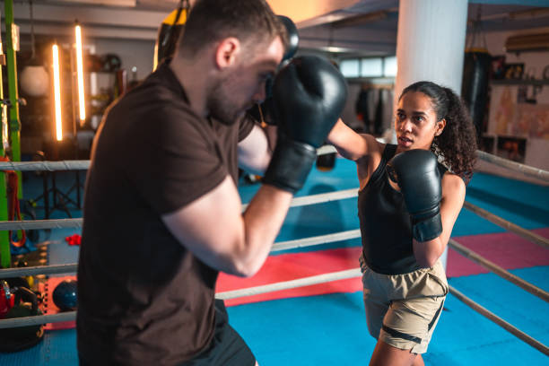 istock Diverse Male And Female Boxers Practicing In A Boxing Ring 1494981686