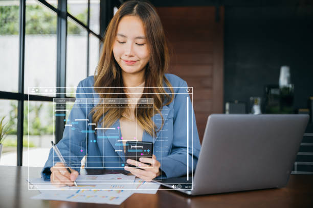 istock woman sitting in cafes holding mobile smart phone she writing note on paperwork chart graph 1494985358