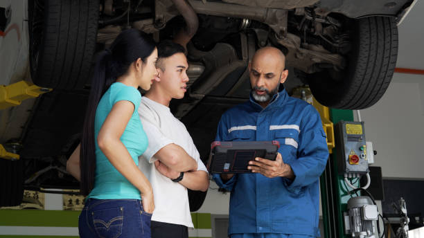 istock Asian auto mechanic explaining car services done to asian couple 1494985739