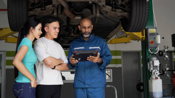 istock Asian auto mechanic explaining car services done to asian couple 1494985746