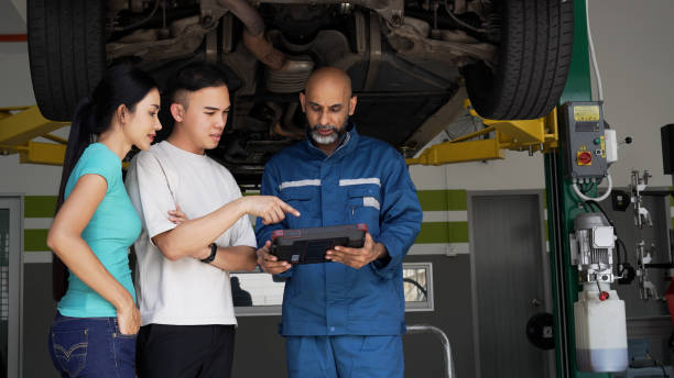 istock Asian auto mechanic explaining car services done to asian couple 1494985754
