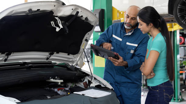 istock Asian female having a conversation with auto mechanic for his car servicing 1494985789