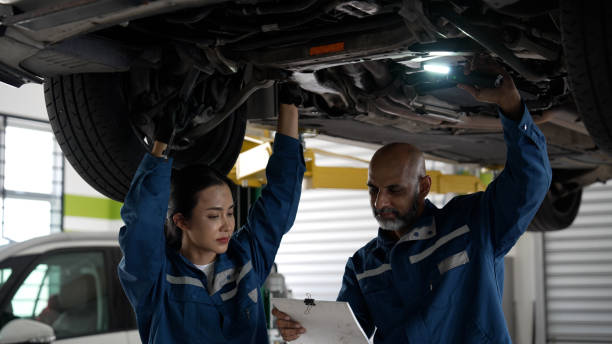 istock Asian senior auto mechanic focused at work with female trainee 1494985914