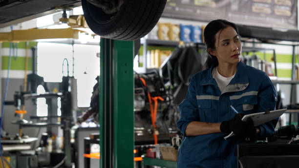 istock Asian female auto mechanic focused at work 1494985949