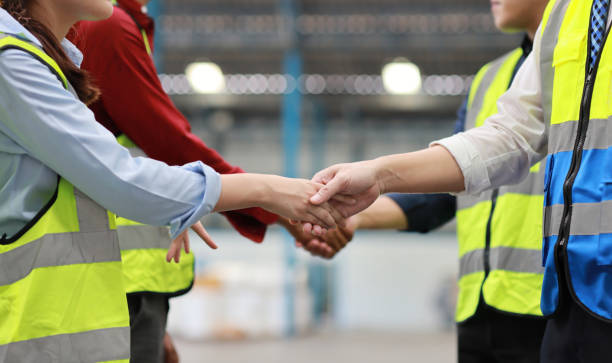 istock Group of technician engineer in protective uniform with hardhat standing and shaking hands celebrate successful together or completed deal commitment at industry warehouse manufacturing factory 1494988325