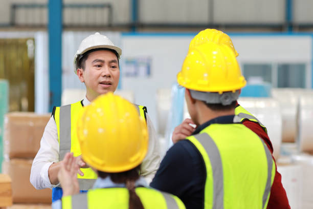 istock Group of technician engineer and businessman in protective uniform standing and discussing, researching, brainstorming and planning work together with protection mask at industry manufacturing factory 1494988355