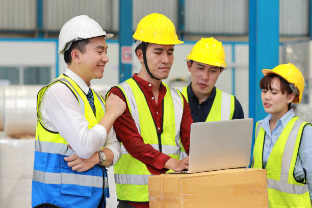 istock Group of technician engineer and businessman in protective uniform standing and discussing, researching, brainstorming and planning work with computer together at industry manufacturing factory 1494988386