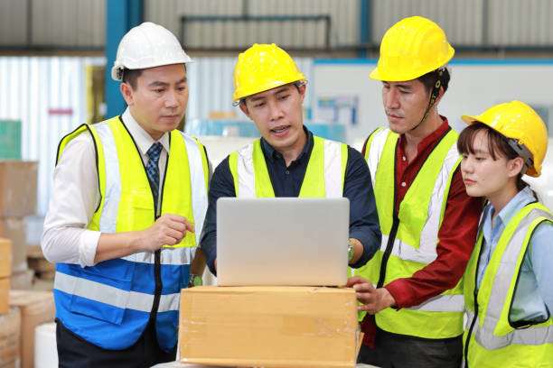 istock Group of technician engineer and businessman in protective uniform standing and discussing, researching, brainstorming and planning work with computer together at industry manufacturing factory 1494988389