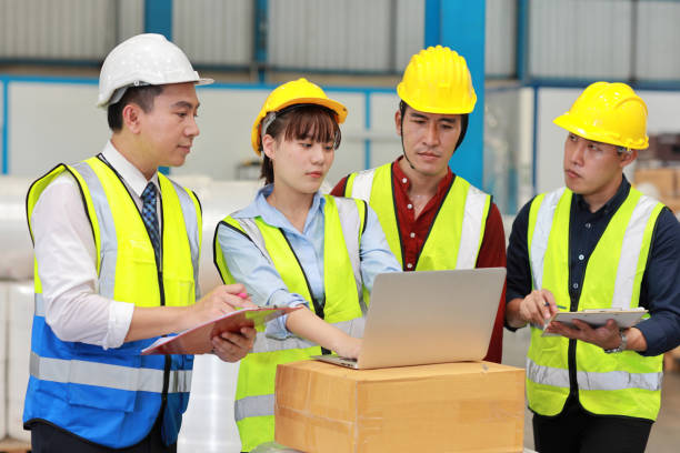 istock Group of technician engineer and businessman in protective uniform standing and discussing, researching, brainstorming and planning work together with computer at industry manufacturing factory 1494988396