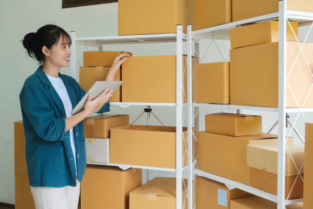 istock Online store owner checking orders for packaged product. 1494990888