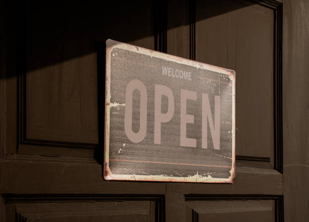 istock Sign with message Welcome OPEN on black wooden door 1494998278
