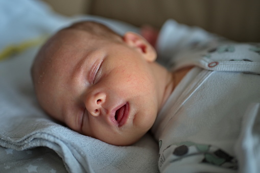 Portrait of cute newborn baby sleeping on blanket