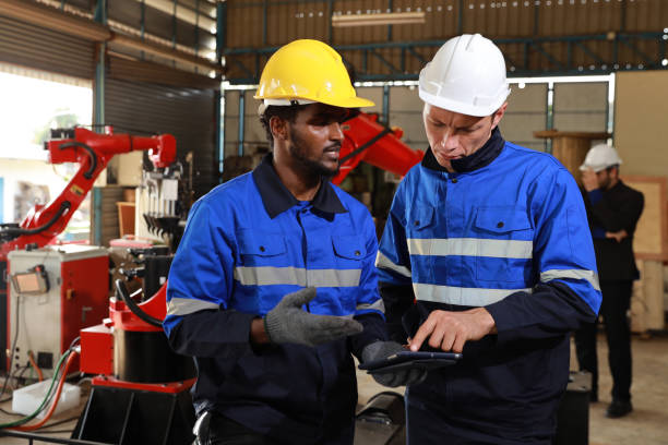 istock Professional heavy industry technician engineer maintenance and check part of robot arm machine in intelligent factory with computer and walkie talkie. Industrial and technology support system concept 1495002244