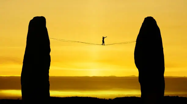 Man balancing on the rope challenge and risk taking concept of risk taking