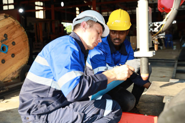 istock Professional heavy industry technician engineer in safety workwear maintenance and check part of robot arm machine in intelligent factory automotive. Industrial and technology support system concept 1495002418