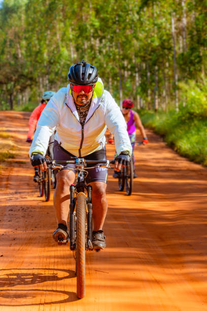 istock Man using his bicycle for leisure and physical conditioning on a trail through the woods 1495006855