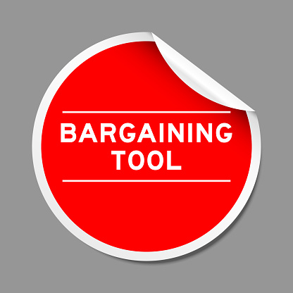 Red color peel sticker label with word bargaining tool on gray background