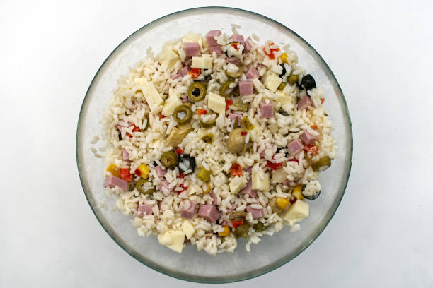 Cold summer rice salad isolated on white. Top view.