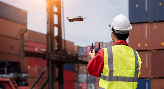 Inspectors use drones to check the security inside the container yard, Cargo freight ship for Logistic Import Export