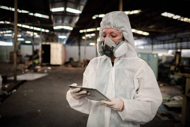 istock Portrait industry worker with safety uniform protective wearing gas mask to safe before start work to check chemical or gas in factory is industry safety concept. 1495010128
