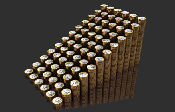 Stack of coins with euro coin and bullet on top with coins blurred background.