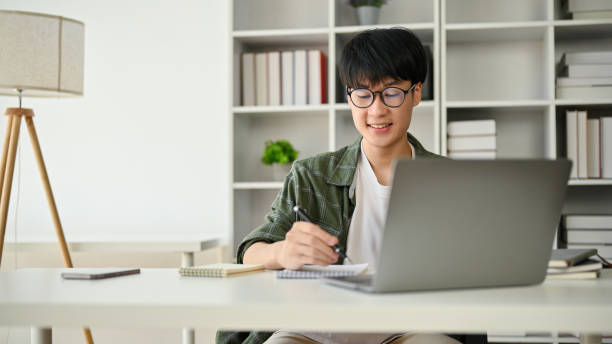 istock A smart Asian male office worker is taking notes on a notepad and focusing on his work 1495010984