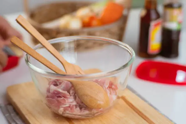 Photo of Step-by-step procedures to marinate pork for easy Korean cooking, add chopped onions and Japanese bunching onion, sesame oil, soy sauce, Korean gochujang and mix well. Korean homemade food for lunch