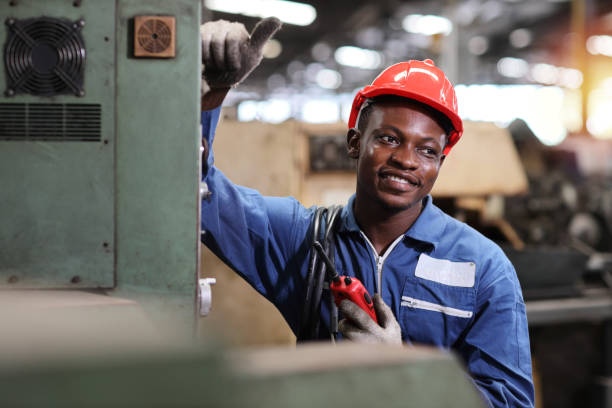 istock Technician engineer and worker in protective uniform standing and holding walkie talkie and showing thumb up after controlling operation checking industry machine process at industry manufacturing 1495014388