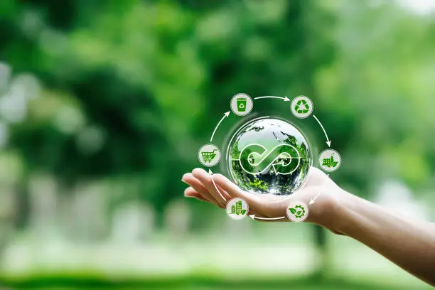 Hand-holding crystal globe with icon circular economy for carbon credit and CO2 emissions reduction. materials and products to reuse and renewable material resources, reuse, renewable, and repair,