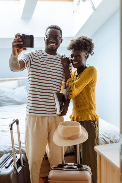 istock African American couple is ready for a trip and taking selfie 1495016388