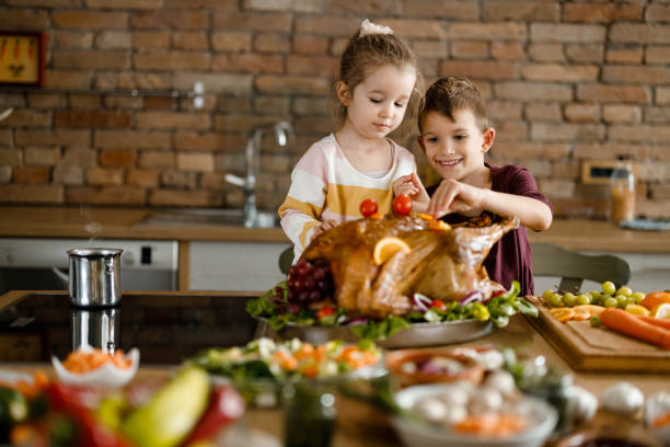 istock Little siblings having fun during Thanksgiving day in the kitchen. 1495018440