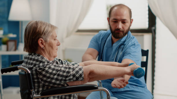 istock Nurse assisting disabled patient with physical exercises for recovery 1495020694