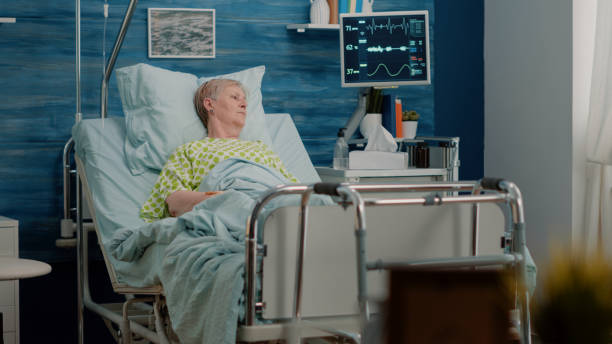 istock Elder patient with sickness laying in hospital bed 1495020762