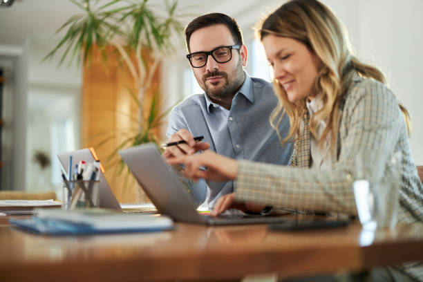 istock Business couple working on a computer at home office. 1495021145